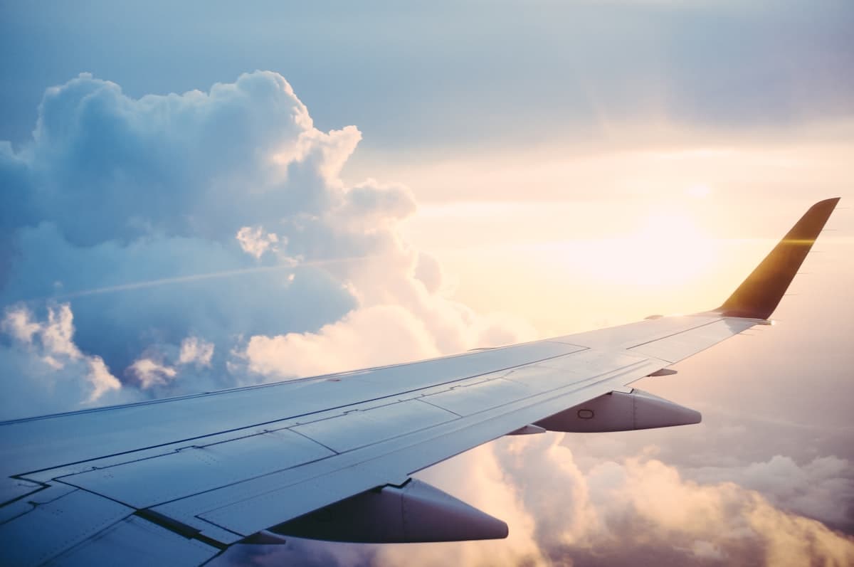 Airplane wing seen through a passenger window during a daytime flight
