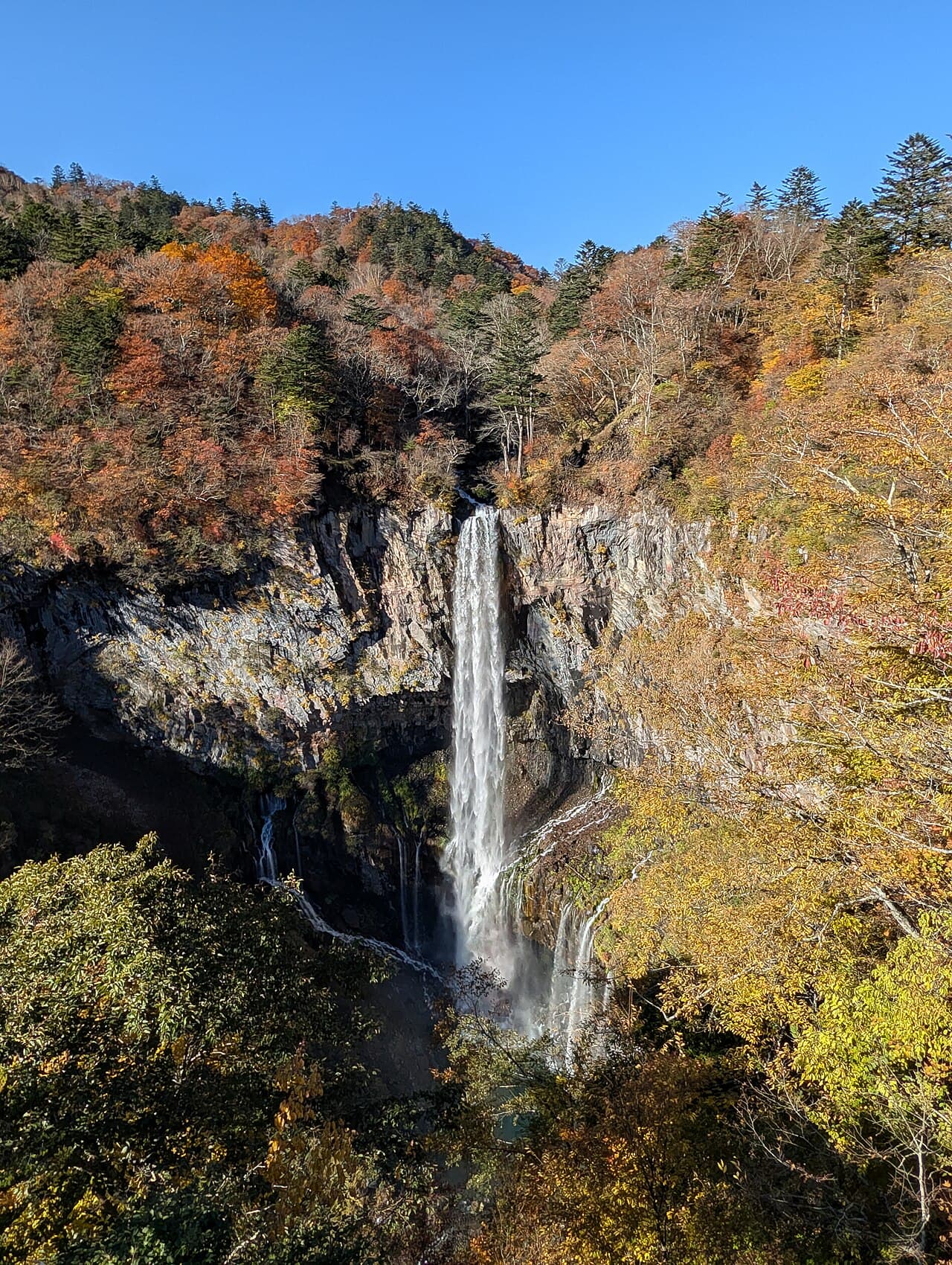 Kegon Falls plunging through a forested valley in Nikko National Park, Tochigi, Japan